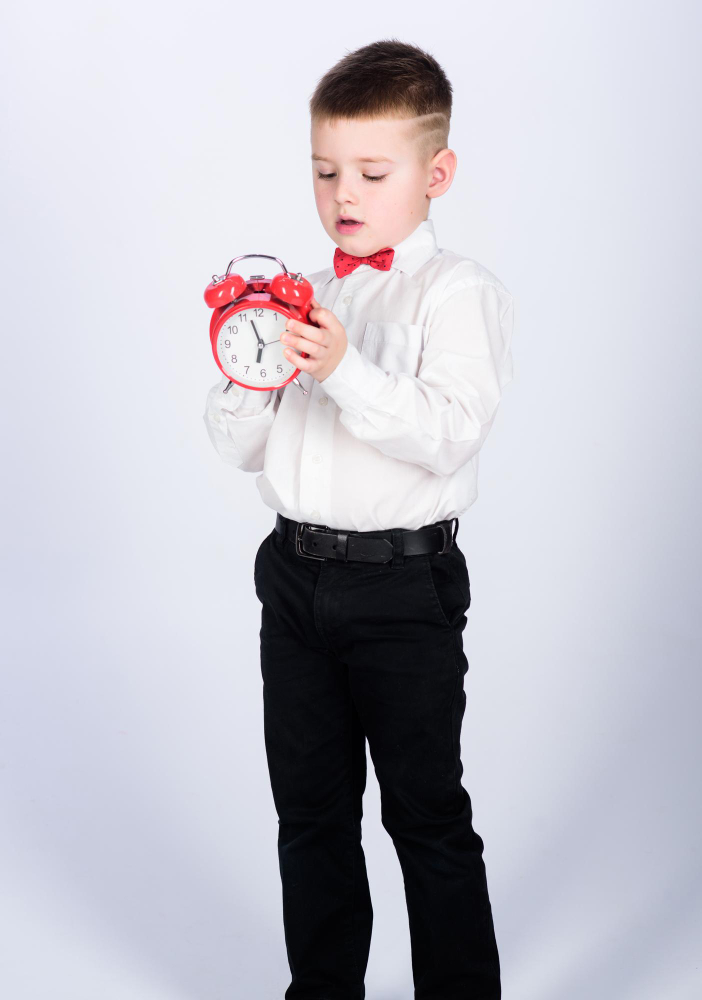 happy-child-with-retro-clock-bow-tie-party-time-businessman-formal-wear-time-management-morning-little-boy-with-alarm-clock-time-relax-tuxedo-kid-happy-childhood-good-start-morning