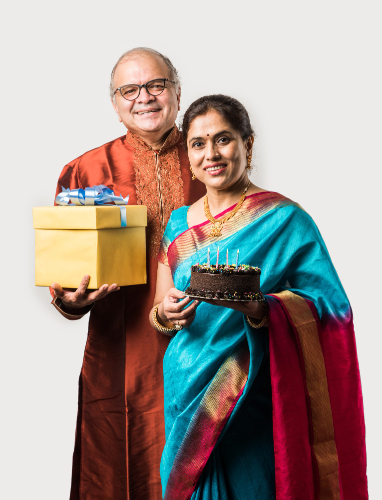 indian-cheerful-old-couple-celebrating-birthday-with-chocolate-cake-while-wearing-ethnic-traditional-cloths