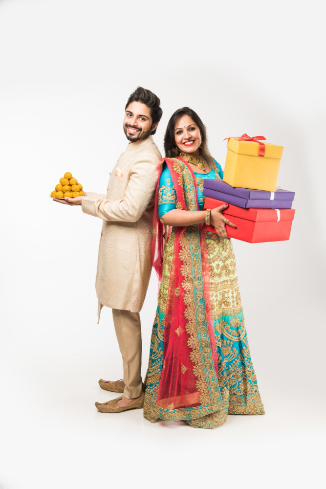 indian-couple-with-laddu-gift-boxes-diwali-festival-standing-isolated-white-background-wearing-traditional-cloths
